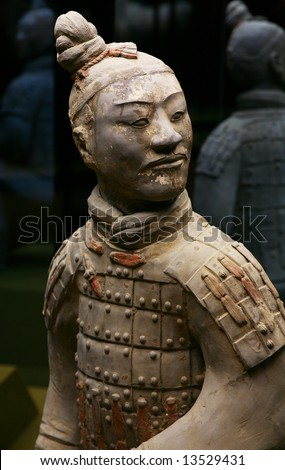 The ancient sculpture of the Chinese soldier in an armour looks to the right