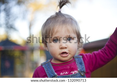 Blond hair blue eyed baby girl with pony tail