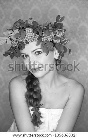 Closeup Portrait of a young beautiful woman a wreath of rowan and with braid hairdo. Natural Beauty. Black and white