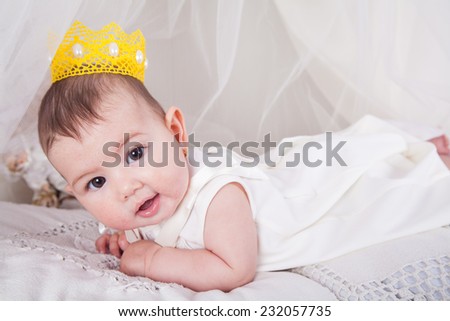 baby smiling with a crown
