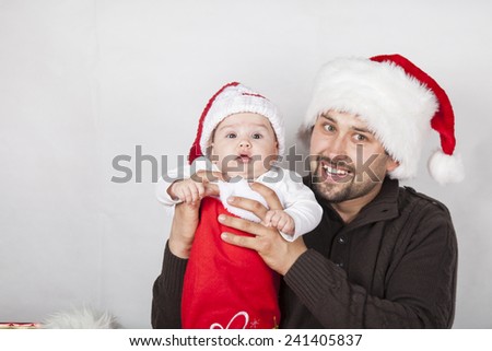 Happy dad with baby in festive clothes and Christmas interior,. Christmas, Holidays, New Year