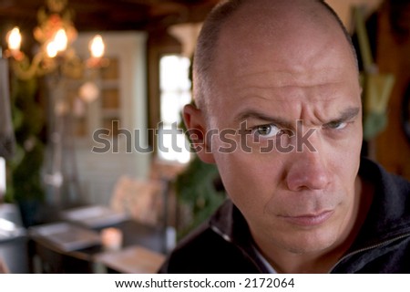 Man with suspicious facial expression (Photo taken in an antique shop)