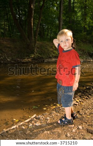 Boy throwing stones in the water