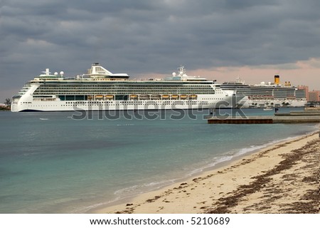 Cruise ship at dock with dark sky after a storm.