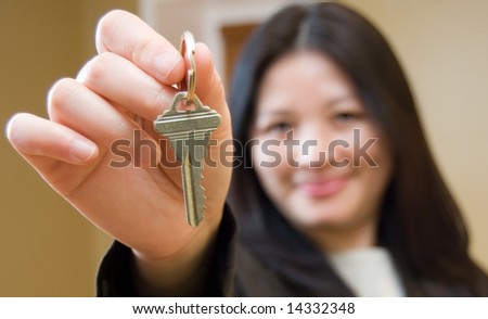 Woman Realtor offering key to house