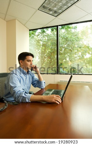 Professional worker working with laptop in window office