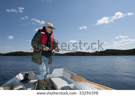 man on boat fishing on fresh water lake