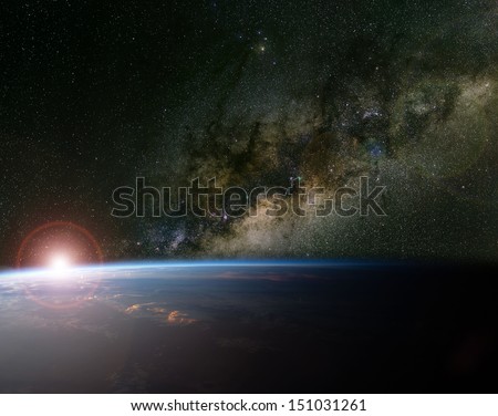 The Milky Way and sunrise over planet Earth. Elements of this image furnished by NASA.
