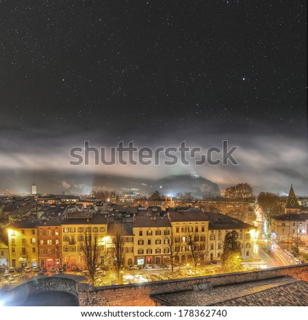 The night sky above a mountain town. This is Trento in Northern Italy.