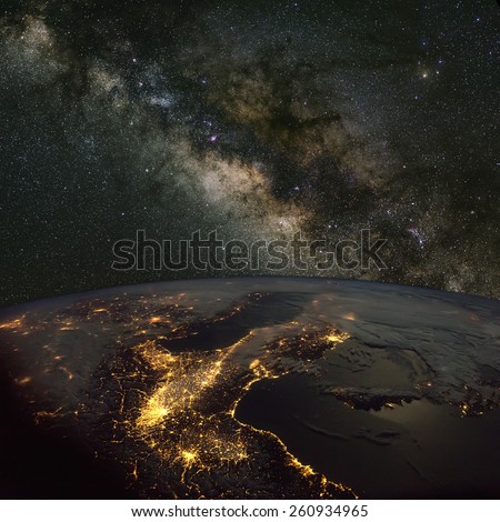 Italy from space at night with the Milky Way above. Elements of this image furnished by NASA.