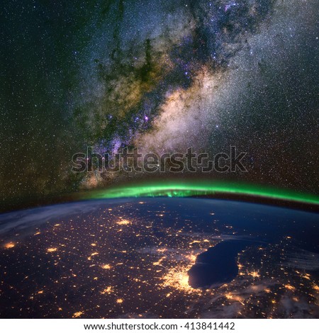 Chicago and lake Michigan from space at night, with the aurora Borealis and the Milky Way. Elements of this image furnished by NASA.