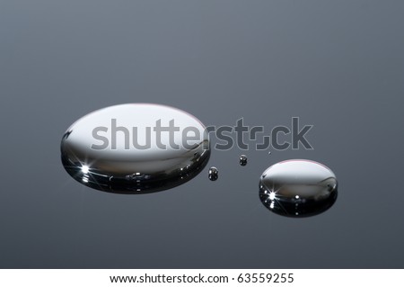Droplets of mercury on a reflective surface