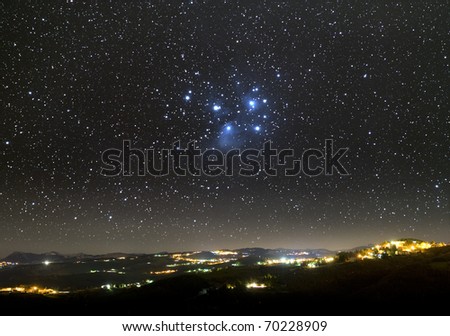 The Universe above city lights. The Pleiades star cluster.