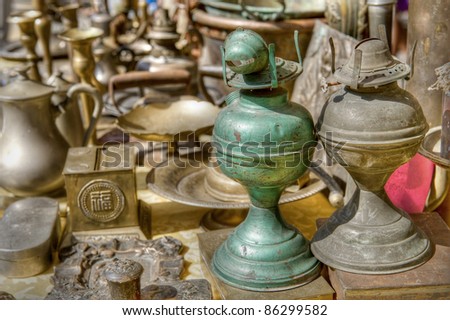Brass antiques at a market stall. High dynamic range image.