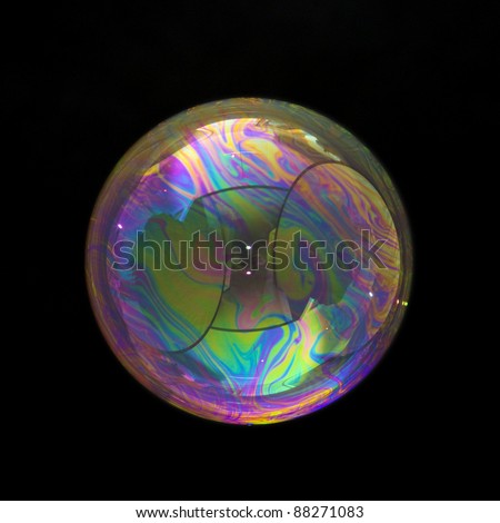 Party soap bubble. Isolated on black. Reflections form a smiley face. Extremely detailed.