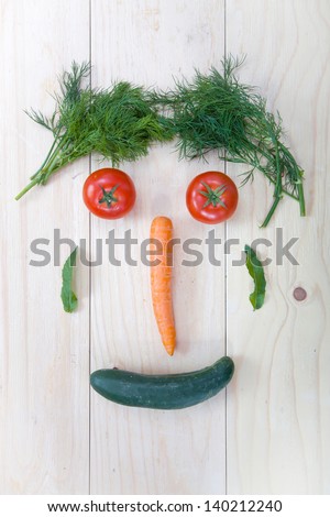 Mix of fresh vegetables arranged like smiling face