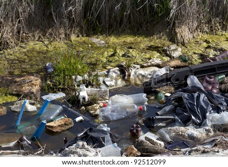 Plastic bottles and rest of a dump in a river