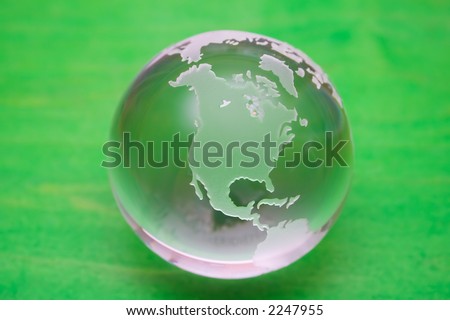 Crystal ball globe on green painted background
