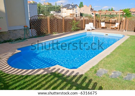 Brand new garden swimming pool with sparkling fresh water. Relaxing pergola with wooden garden furniture.