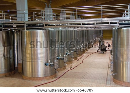 Wine Fermenting in huge vats in a famous wine cellar in spain.