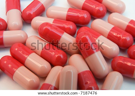 Pharmaceutical background. Red capsules close-up.
