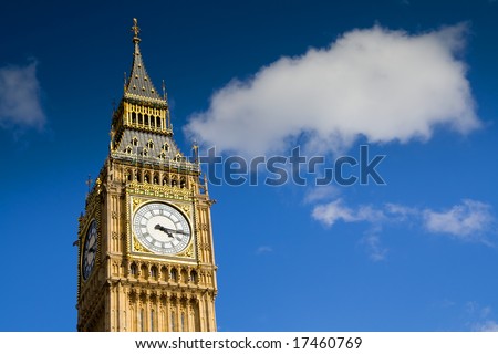 Big Ben, Westminster, London. Clock tower under a blue sky with a fluffy cloud