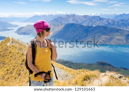 Young woman with backpack has a rest