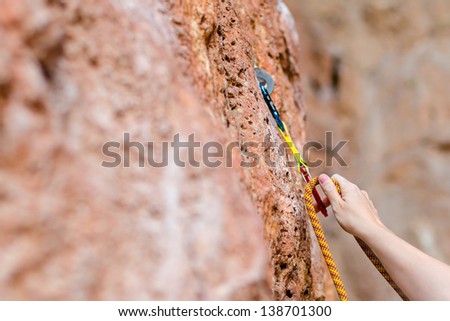 Rock climber\'s hands on handhold