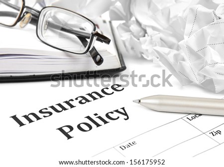 insurance policy form on desk in office showing risk concept. Life; Health, car, travel