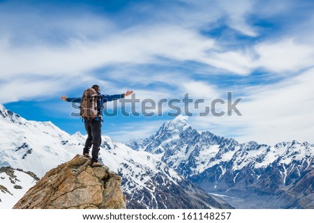Hiker Cheering Elated And Blissful With Arms Raised In The Sky After Hiking To Mountain Top Summit Above The Clouds
