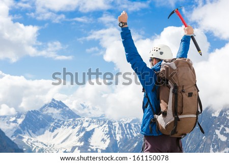 Winner / Success Concept. Hiker Cheering Elated And Blissful With Arms Raised In The Sky After Hiking To Mountain Top Summit Above The Clouds