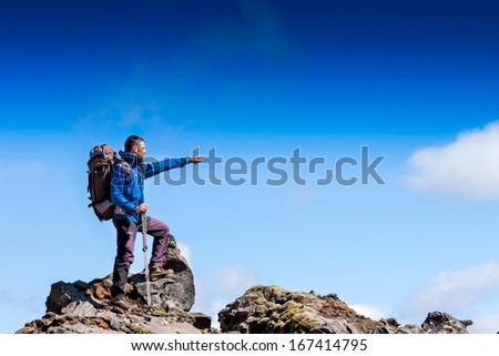Hiker Looking At The Horizon In The Mountains On Sunny Day