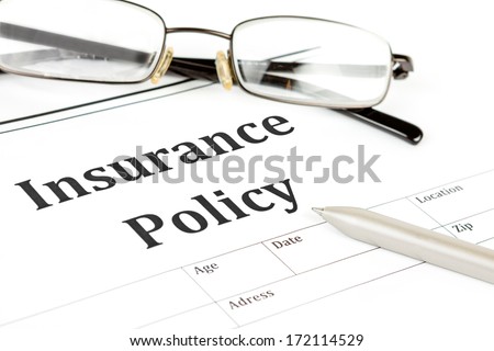 insurance policy form on desk in office showing risk concept. Life; Health, car, travel