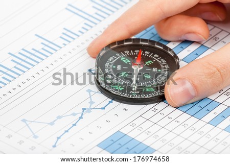 business navigation concept with compass and diagram or graph