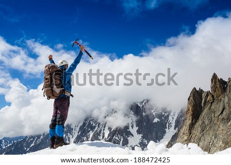 Winner Success concept Hiker cheering elated and blissful with arms raised in the sky after hiking to mountain top summit above the clouds Winner Success concept Hiker cheering elated and blissful with arms raised in the sky after hiking to mountain top summit above the clouds
