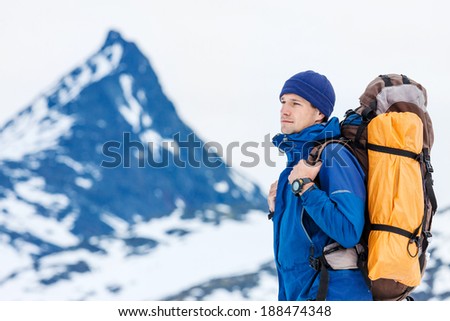 close up portrait of hiker looking at the horizon high in the mountains