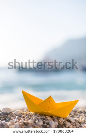 Yellow paper boats on the beach