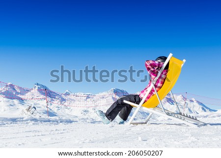 Girl relax in snowy mountains. Ski vacation