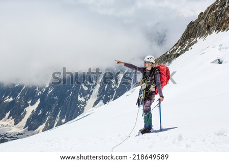 Hiker looking at the horizon in the mountains on sunny day
