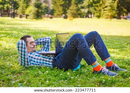 Young man lie down and resting with laptop