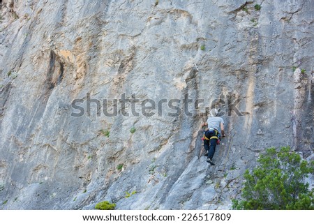 Young man start climbing on a wall
