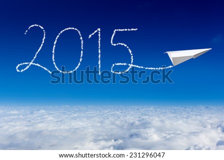 Paper plane flying and drawing 2015 in the sky. happy new year 2015