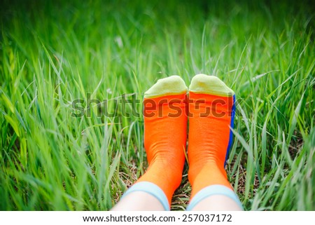 bare feet in socks on green grass, copy space