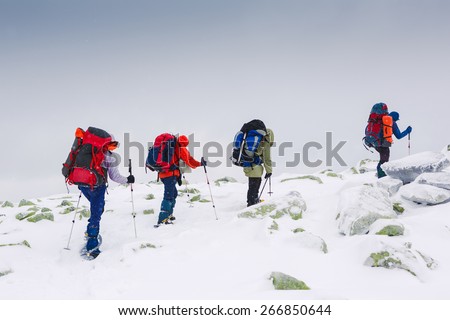people hiking in winter mountains - healthy active lifestyle