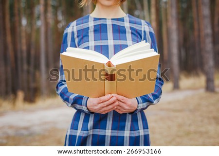 woman holding open book