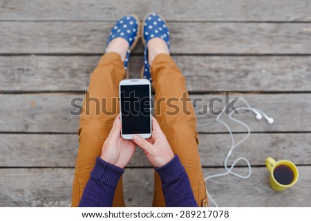 Beautiful young woman using smart phone at beach