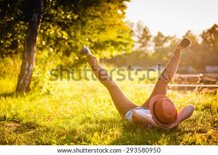 Trendy Hipster Girl Relaxing on the Grass