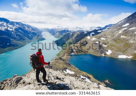Traveler with backpack and mountain panorama. Norway