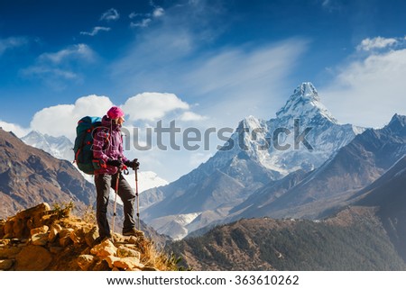 Hiking in Himalaya mountains. Woman Traveler with Backpack hiking in the Mountains. mountaineering sport lifestyle concept