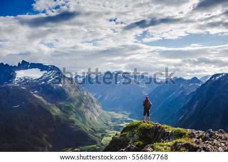 Hiker on the mountain top. Sport and active life concept. Hiking ROMSDALSEGGEN RIDGE, Andalsnes City, Norway
